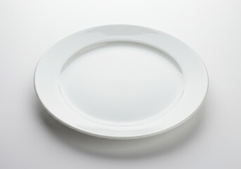 Simple white plate on a white background, ready for food presentation or culinary design mockups