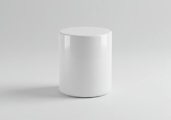 Simple white cylindrical object on a white surface in a minimalist composition with soft lighting