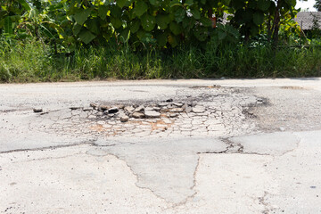 Asphalt road surface damage at local. Occure pothole, gravel and asphalt to broken crack. Dangerous...