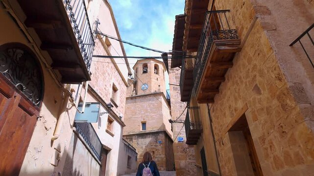 Tourist woman strolling through the steep streets of the picturesque village of Beceite, Teruel, Aragon.