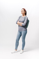 Young woman with a backpack on her shoulders waiting