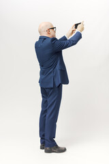 Businessman taking pictures with his smartphone