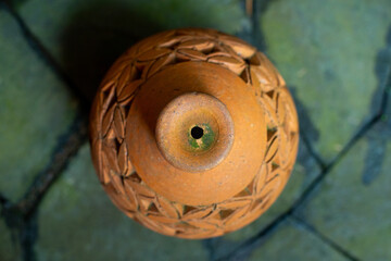 Beautiful oriental decorative terracotta lantern on paved stone floor, with shallow depth of field