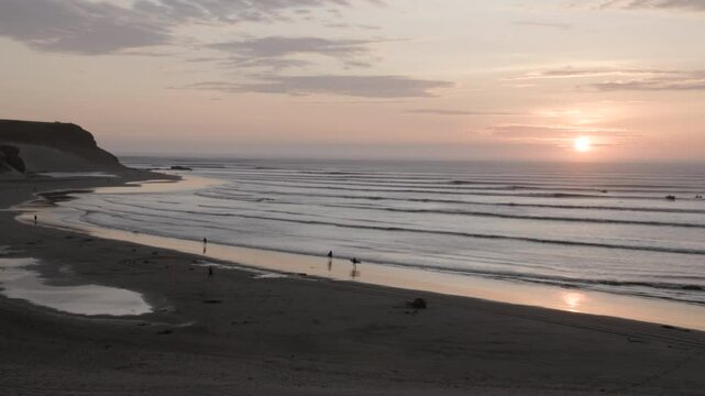 a sunset panning shot of the el point section of chicama, the world's longest lefthand point break at puerto malabrigo, peru