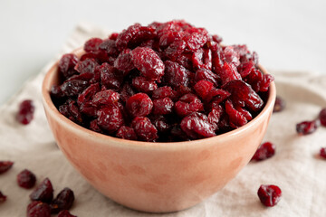 Organic Dried Cranberries in a Bowl, side view. Close-up.