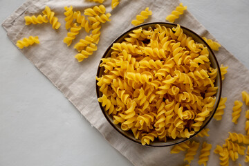 Raw Dry Organic Fusillini Pasta in a Bowl, top view.