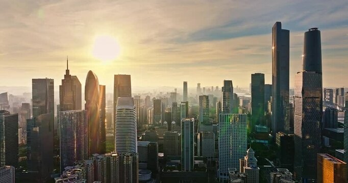 Aerial view of city skyline and modern commercial buildings at sunrise in Guangzhou, China.