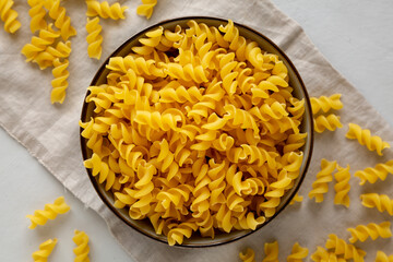 Raw Dry Organic Fusillini Pasta in a Bowl, top view.