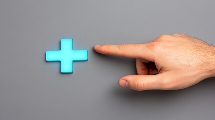 Obraz premium Glowing Blue Plus Sign Icon Pointed at by a Hand on Gray Background Perfect for medical positive or adding concepts