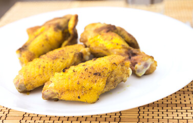 Fried chicken wings on white plate