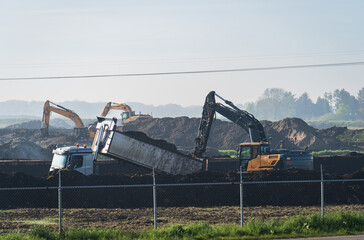 Excavators doing ground work on a construction site in Meerstad.