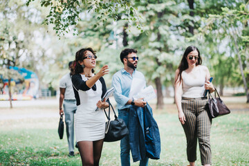 A group of business people walking together in a park, casually discussing ideas. The scene captures movement, teamwork, and outdoor office culture in a natural, relaxed environment.
