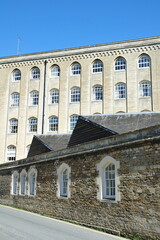 Exterior view of an old factory converted into an apartment building on a street in an English town