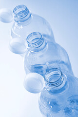 Plastic bottles with so-called tethered caps in monochrome blue. The caps are attached to the drink bottle to prevent it from ending up in nature. The EU bans loose closures and caps on bottles.
