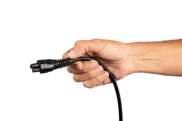 Male hand holding a black computer power cable isolated no background cutout