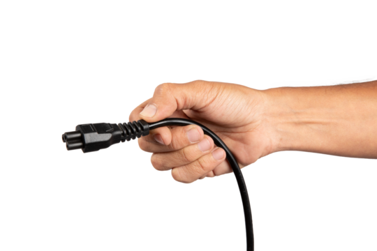 Male hand holding a black computer power cable isolated no background cutout