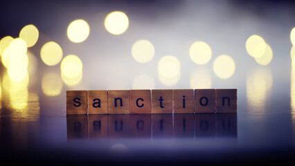 word sanctions spelled in letters on table made of wooden block letters with dramatic lighting and...
