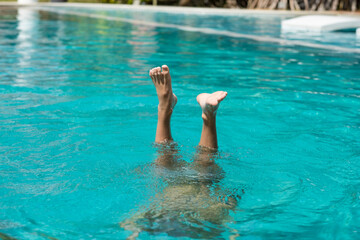 baby's feet out of water in pool	