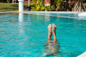baby's feet out of water in pool	