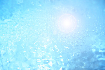 Bubbles and seething water in the light of sunlight.Blue water texture.