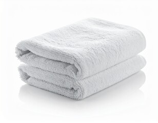 A neatly folded stack of two fluffy, pure white towels, showcasing soft texture. Clean and crisp