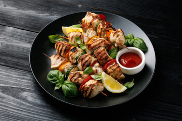 Chicken kebab skewers on a plate with vegetables. Mediterranean healthy food