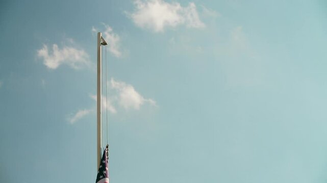 Hoist USA flag with blue sky