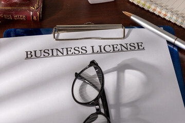 Business License Paper Secured in Clipboard on Office Desk