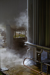 An oxygen station that produces and supplies medical oxygen to a hospital. The station includes radiators and a large white cylinder containing liquefied oxygen for distribution.