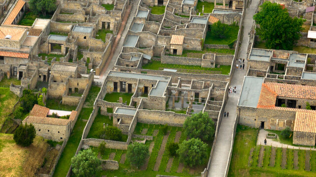Aerial view of the ruins of houses and structures of the ancient Roman city of Pompeii. The archaeological park is located in the province of Naples, Campania, Italy.