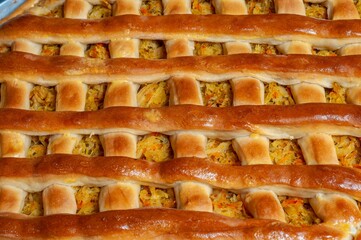 Close-up of a homemade savory pie with a beautifully crafted lattice crust, freshly baked.