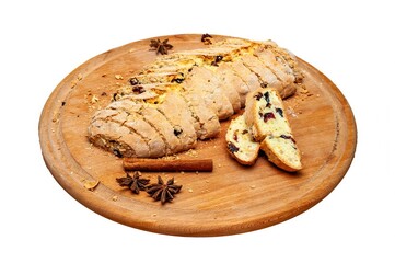 Freshly baked biscotti, elegantly sliced and served with spices on a wooden plate.