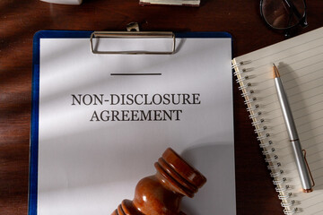 Non-Disclosure Contract Resting Near Gavel, Legal Office Scene