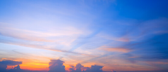Sunset sky background with nature gradient light and clouds on orange and blue evening sky, Idyllic summer panoramic dusk sky backdrop