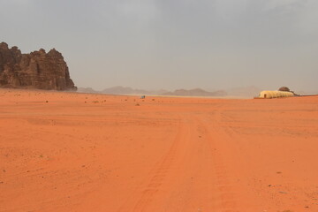 Wadi Rum Desert, Jordan. The red desert and Jabal Al Qattar mountain. 8th July 2023. On a hot spring cloudy day. 