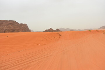 Wadi Rum Desert, Jordan. The red desert and Jabal Al Qattar mountain. 8th July 2023. On a hot spring cloudy day. 