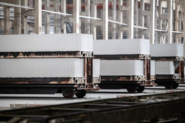 Industrial production of aerated concrete blocks, AAC blocks (Autoclaved aerated concrete), Fly ash or Grey Cement Fly Ash Bricks. Carts with cut blocks are cured after processing in an autoclave.