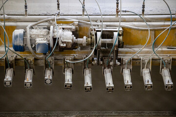 Industrial production of aerated concrete blocks, AAC blocks (Autoclaved aerated concrete), Fly ash or Grey Cement Fly Ash Bricks. The machine cuts the large workpiece into parts with steel strings.