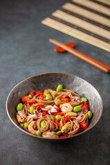 Japanese soba noodles with seafood, edamame beans and vegetables. Asian cuisine