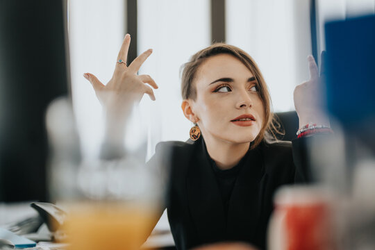 Confident young woman making gestures in a modern office environment.