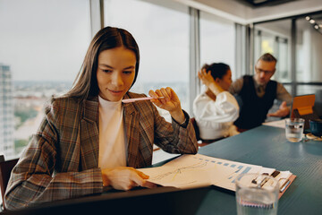 A skilled professional collaborates well with colleagues in a modern, innovative office environment