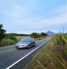 Fast speed driving car motion blur on the road. Mt Ngauruhoe in the distance. Tongariro National Park. New Zealand.