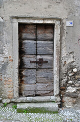 Close Up of Ancient Timber Door in Cobbled Street 