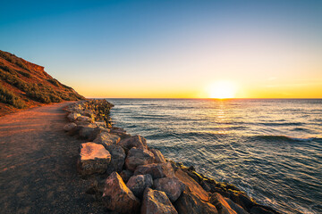 Christies Beach coastline with Witton Bluff trail at sunset while viewed towards west