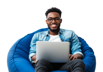 Young Man Sitting in Bean Bag Chair Working on Laptop on a transparent background
