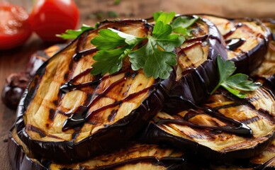 Grilled eggplant slices garnished with fresh parsley and balsamic drizzle on wooden board
