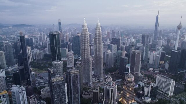 A cinematic drone shot of the Kuala Lumpur City Center twin tower in 4K