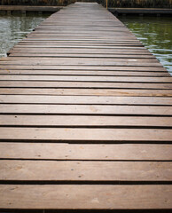 Wooden walkway on the lake, closeup of photo.
