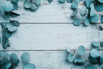 Light blue wooden planks framed by eucalyptus leaves