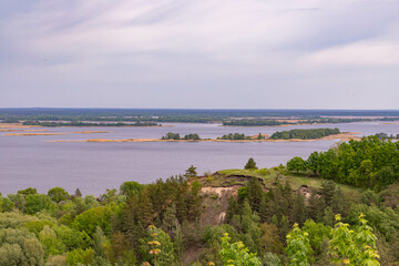 clay slopes covered with forest on the banks of a wide river